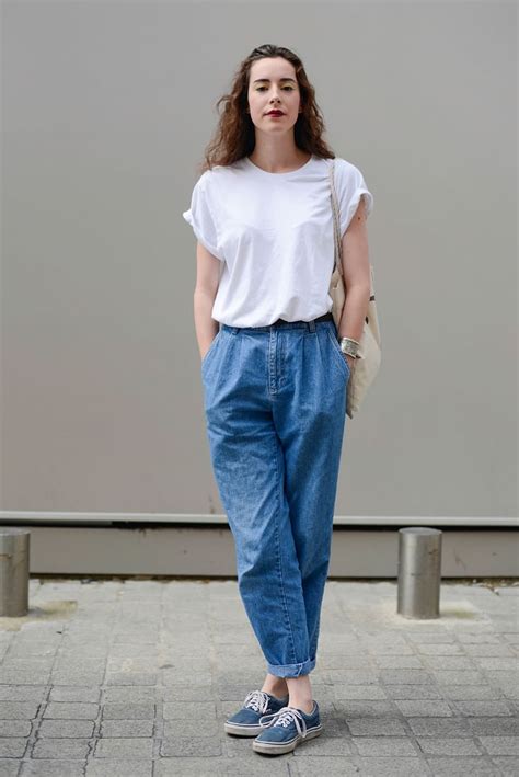with a white tee tucked into baggy denim pants how to wear vans sneakers popsugar fashion