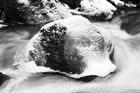 Boulder In Creek With Snow And Ice