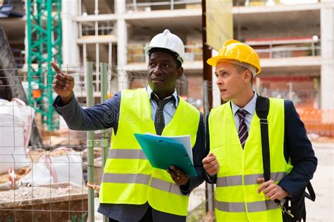 African American Engineer Discussing A Construction Plan With A
