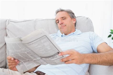Man In Living Room Reading Newspaper Smiling Stock Photo Image Of