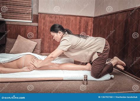Serious Female Masseuse Massaging Her Clients Body Stock Photo Image