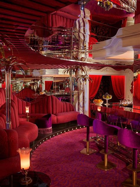 The Interior Of A Fancy Restaurant With Red And Purple Decor