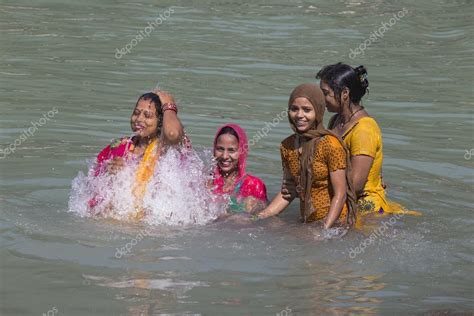 Indian Woman Wash Themselves In The River Ganges In The Holy City Of Rishikesh India Stock