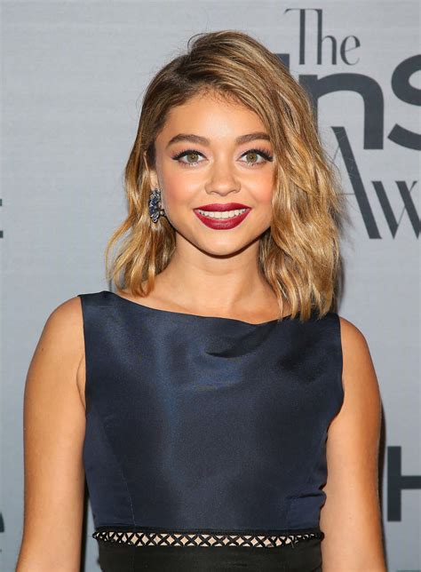 Download Sarah Hyland looking stunning in a white dress at an event