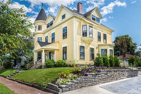 Examples of stone coated steel and standing seam metal roofs on colonial homes. 12 Charming Yellow Houses - Town & Country Living