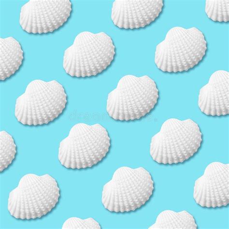 Creative Seashell Pattern On Pastel Blue Background With