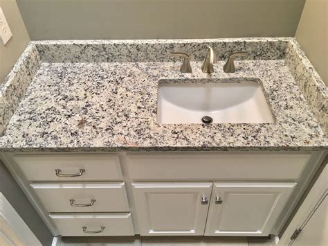 Different brushes are available with it. Ashen white granite countertops, Moen 8" widespread faucet ...
