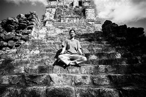 Japanese Woman Meditating On Staircase To Temple Photo12 Tetra Images
