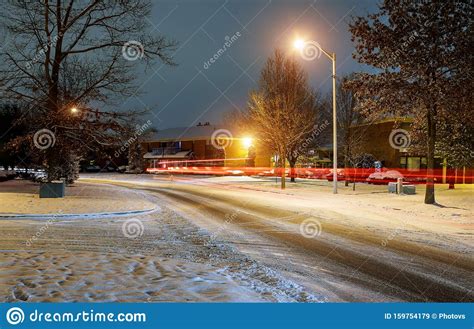 Car Light In Night On Ice Road In In The Residential Area Snow Falling