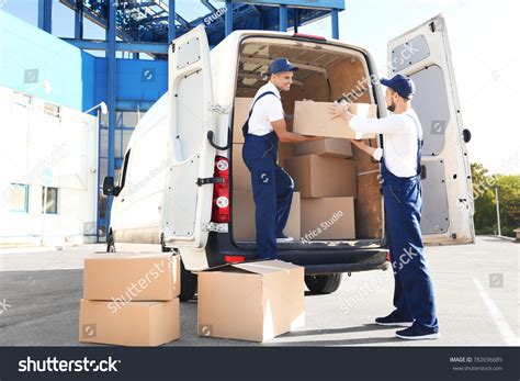Delivery Men Unloading Moving Boxes Car Stock Photo 782696689