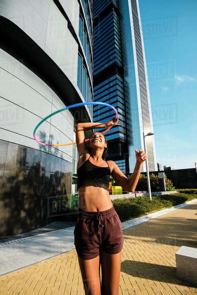 Mixed Race Generation Z Woman Performing Hula Hoop Dance In Downtown