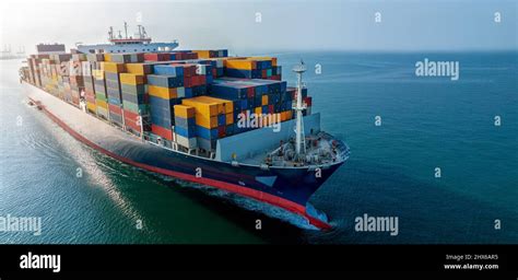 Aerial Side View Of Cargo Ship Carrying Container And Running For