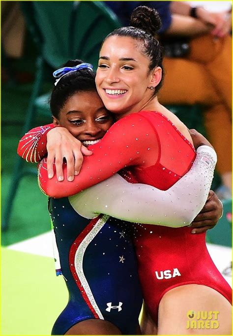 two women hugging each other in front of people