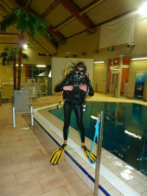 A Man In Scuba Gear Standing Next To A Swimming Pool