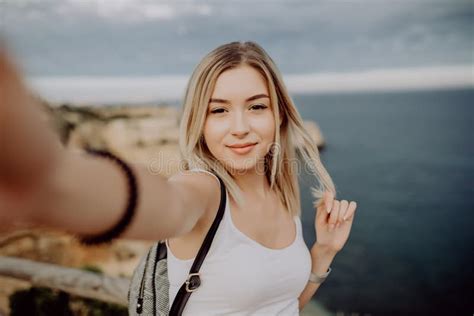 Beautiful Young Woman Doing Selfie On The Cliff Ocean Beach Stock Image