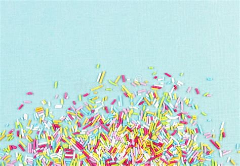Culinary Pastry Rainbow Sprinkles Are Scattered On A White Background