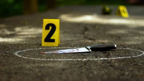 Crime Scene With Bloody Knife And Shoe That Fell Off Yellow Markers