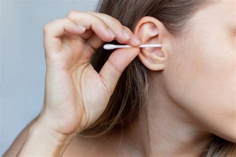 Premium Photo Cropped Shot Of A Young Woman Cleaning Her Ear With A