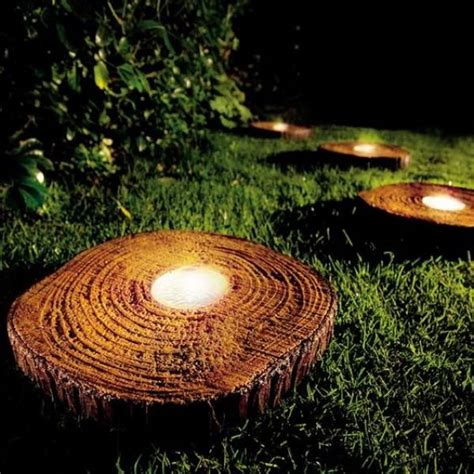 Several Lit Candles Are Placed In The Grass