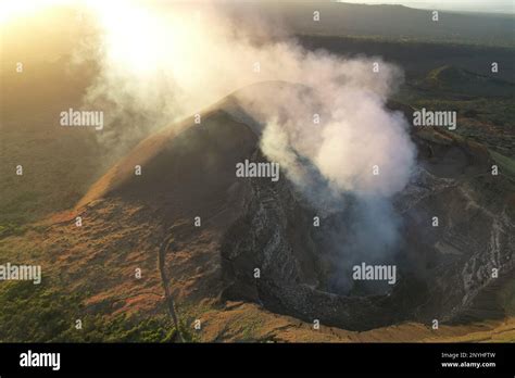 Volcanic Masaya Crater With Big Smoke Cloud On Sunset Time Background
