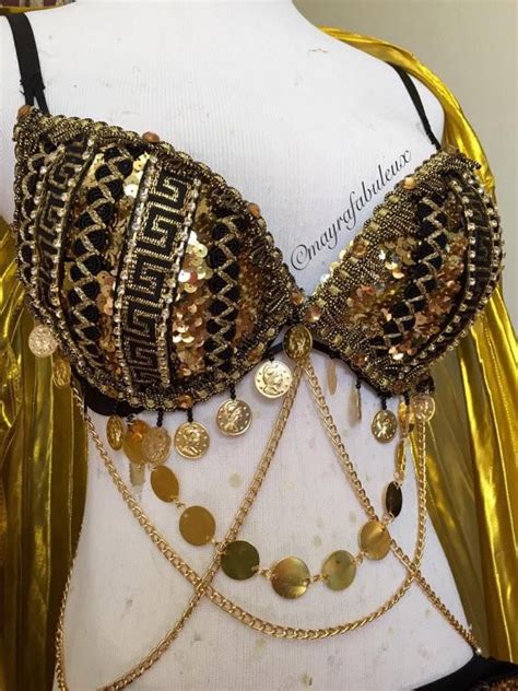 a close up of a bra on a mannequin with gold chains and coins
