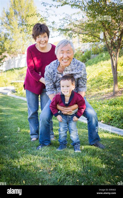 Happy Chinese Grandparents Having Fun With Their Mixed Race Grandson