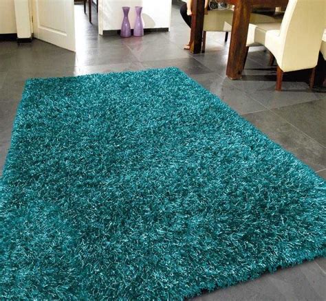 A Bright Blue Rug Is On The Floor In Front Of A Dining Room Table And