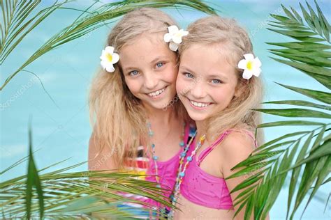 Portrait Of Two Girls In A Swimming Pool Stock Photo By ©zagorodnaya