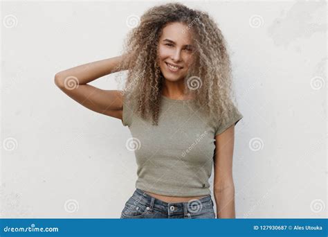 Happy Beautiful Young Girl With Curly Hair With A Smile Stock Image