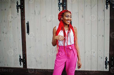 fashionable african american girl at pink pants and red dreads posed outdoor 10483270 stock
