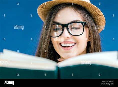 Portrait Of Beautiful Smiling Brunette Girl Wears Eyeglasses Reading