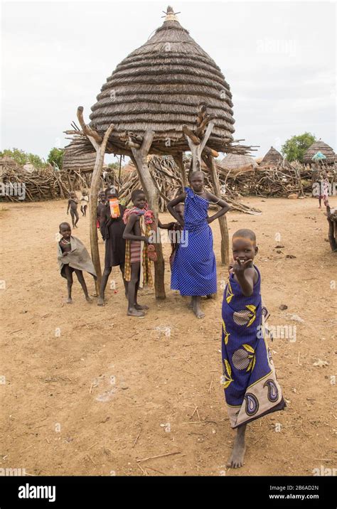 Toposa Tribe Children Standing Near A Granary In A Village Namorunyang