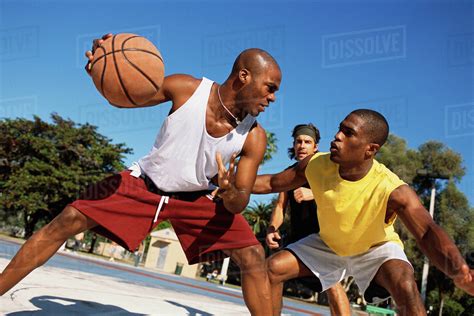 Men Playing Basketball Outdoors Stock Photo Dissolve