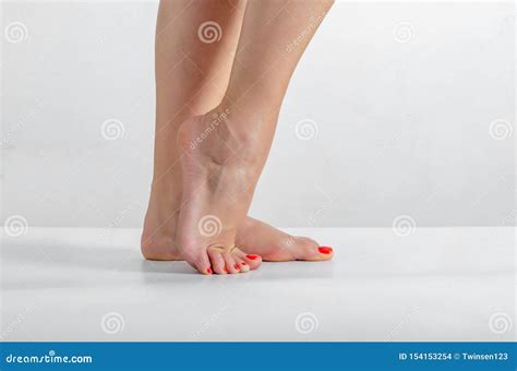 Female Feet Feet Stand On A White Background Smooth Skin Foot Care