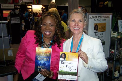 Cindy Trimm and April Shenandoah sharing a moment with their books at