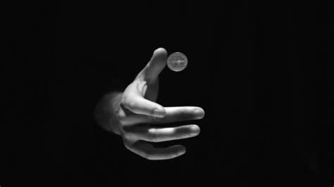 Best price guaranteed simple licensing. Hand flipping a coin in black and white — Stock Video ...