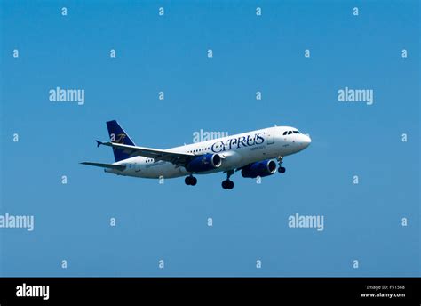 A Cyprus Airways Airplane Descending Towards The Airport Stock Photo