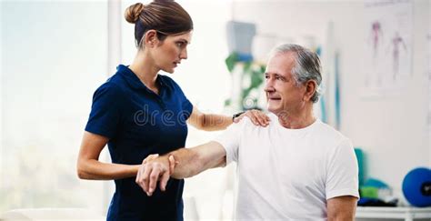 Physiotherapy Doctor Senior Patient And Stretching Arm Physical