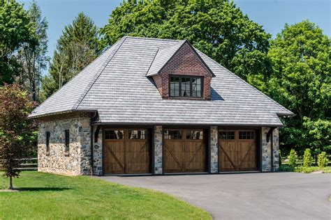 Carriage Style Garage With Stone Brick And Composite Slate Roof In