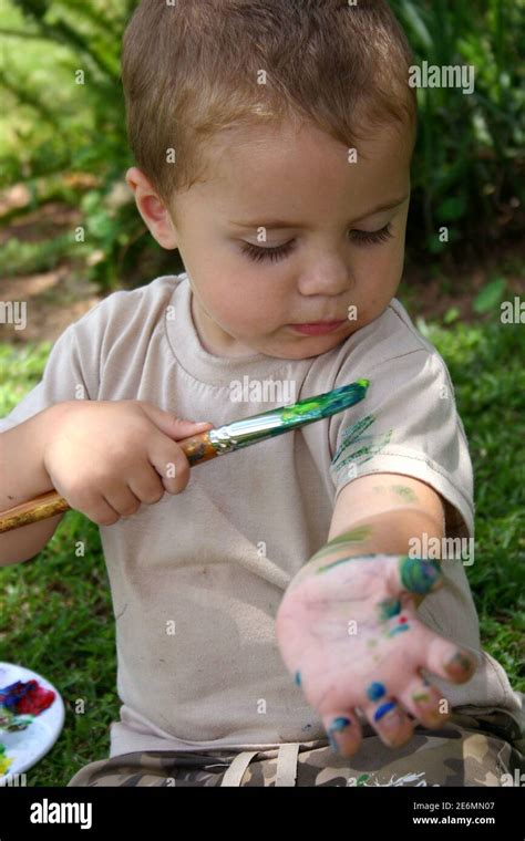 Toddler Painting Himself Stock Photo Alamy