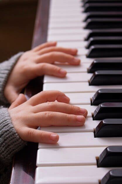 Premium Photo Cropped Hands Of Kid Playing Old Piano