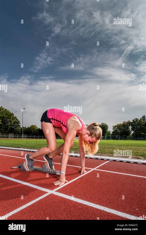 Female Runner In Starting Position Stock Photo Alamy