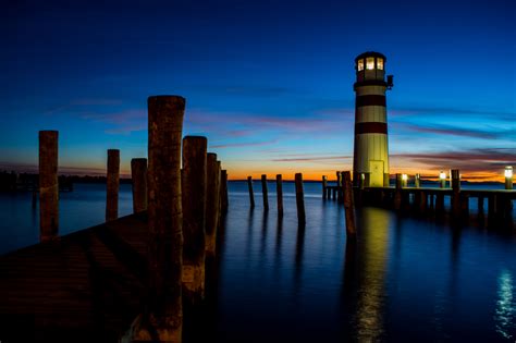 Lighthouse Near Body Of Water During Night Time Hd Wallpaper