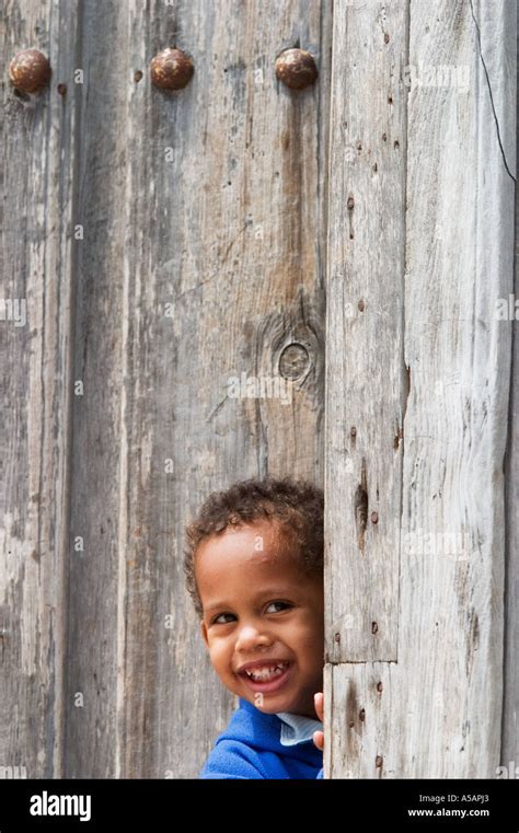 Boy Smiling Outside Of Doorway Gibara Cuba Stock Photo Alamy
