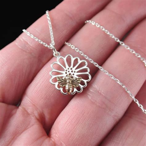 Dainty Mixed Metal Necklace Featuring A Small Sterling Silver Daisy