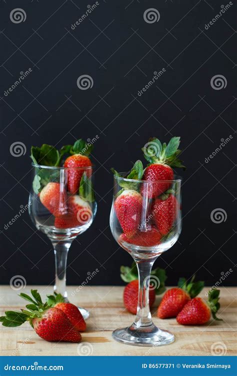 Two Vine Glasses Filled With Fresh Strawberry On Wooden Table Stock