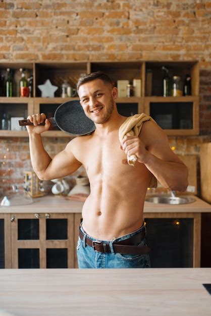 Premium Photo Muscular Man With Naked Body Holds Frying Pan On The Kitchen Nude Male Person