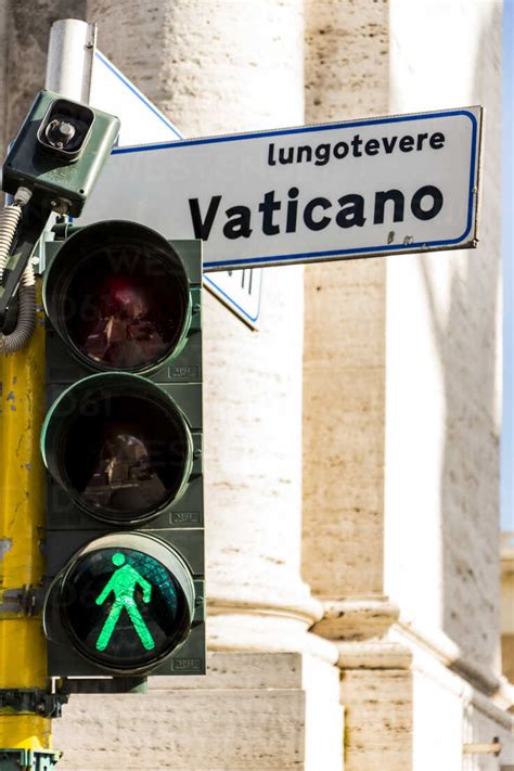 Italy Rome Green Traffic Light And Road Sign In Vatican City Stock Photo