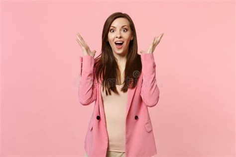 Portrait Of Surprised Young Woman In Jacket Keeping Mouth Wide Open Spreading Hands Isolated On