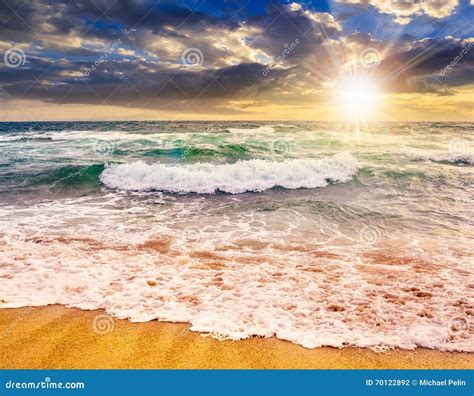 Sea â€‹â€‹waves Crashing On Sandy Beach At Sunset Stock Photo Image